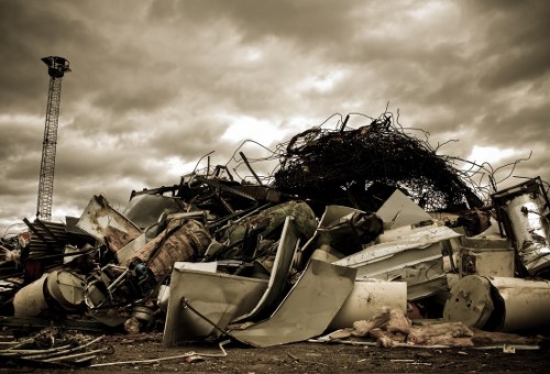 Photo of staff inspecting a skip and noting details during an investigation